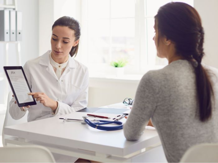Female Doctor pointing to ipad